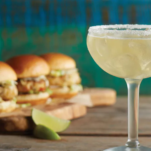 Tre burgare och en cocktail med lime.